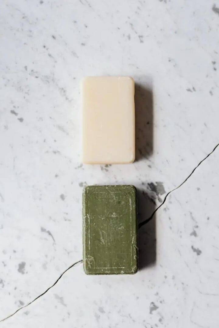 Two soaps sitting on top of a counter.