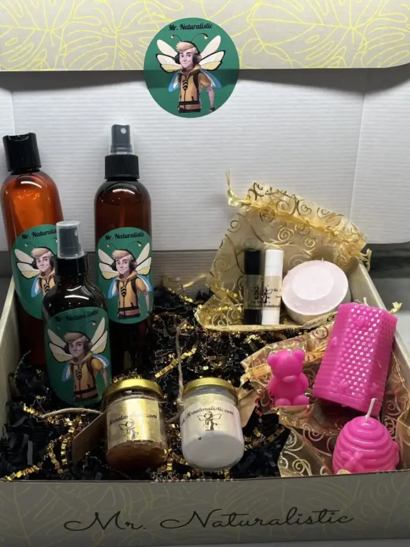 A box of products with a candle and other items.